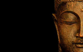 Buddha statue closeup black background - facial feature free wallpaper