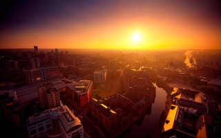 Sunset city river buildings smoke - a sunset over a city free wallpaper