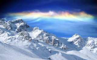 Rainbow snowy mountain range distance - colorful cloud free wallpaper