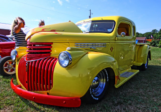 Yellow truck grass field woman - a yellow truck free wallpaper