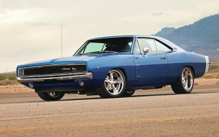Blue muscle car desert mountains - a cloudy sky free wallpaper