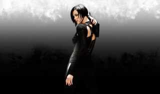 Woman black dress black background - behind her free wallpaper