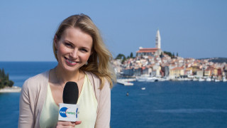 Woman microphone body of water - a city in the background and a boat free wallpaper