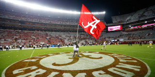 Man holding flag field stadium - a crowd of people watching free wallpaper