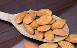 Wooden spoon almonds table food - a wooden spoon free wallpaper