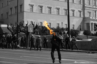 Man running street fire stick - a crowd of people behind free wallpaper