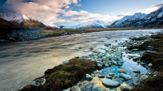 River lush valley cloudy sky 3 - a lush green valley under a cloudy sky free wallpaper