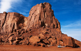 Car parked rock formation desert - derek chittock free wallpaper
