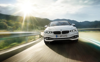 White car driving road mountains - the background and sun free wallpaper