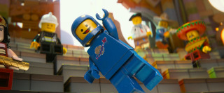 Lego character holding figure stage - action scene free wallpaper