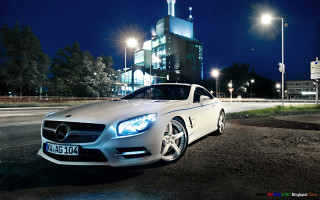White car parked night building - the side of a road free wallpaper
