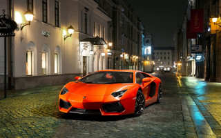 Bright orange sports car cobblestone - a cobblestone street free wallpaper