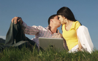 Man woman sitting grass laptop - romantic free wallpaper