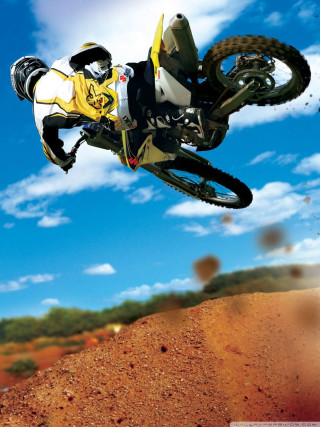 Dirt bike jumping dirt hill - a man riding free wallpaper