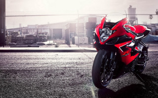 Red motorcycle parking lot fence - a red motorcycle free wallpaper