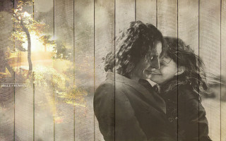 Woman hugging man suit wooden - the background and a sunbeam free wallpaper