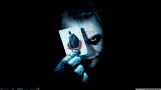 Joker holding card evil look - free dark wallpaper