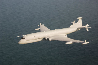Large white airplane flying ocean - over the ocean water free wallpaper