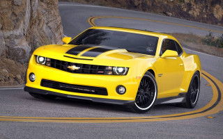 Yellow car winding road rock - road free wallpaper