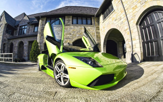 Green sports car parked house - a green sports car free wallpaper