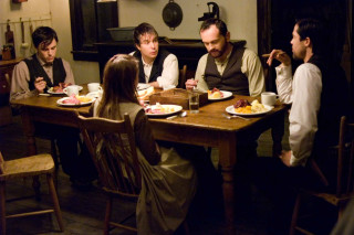 Group people sitting table eating - a group of people sitting free wallpaper