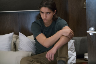 Man sitting bed arms crossed - everett warner free wallpaper