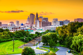 City skyline winding road sunset - cleve gray free wallpaper