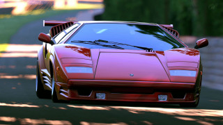 Red sports car driving green - a road next free wallpaper