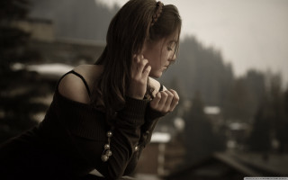 Woman black dress hands chest - somber free wallpaper
