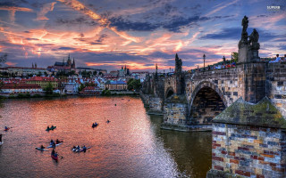 People rowing boat river cloudy - a bridge in the background free wallpaper
