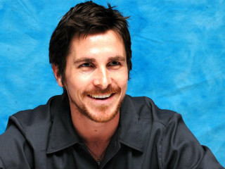 Man beard black shirt smiling - a blue backdrop free wallpaper
