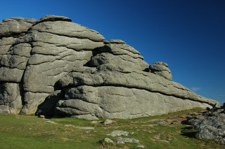 Large rock formation grass sunny - hard edge free wallpaper