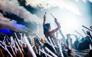 Man holding white sticks concert - neon free wallpaper