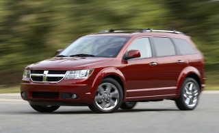 Red dodge suv driving road - a forest of trees and bushes free wallpaper
