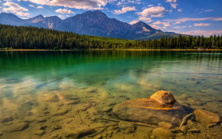 Lake rock mountains background clouds - a rock in the middle of it free wallpaper