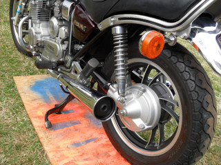 Motorcycle parked grass red light - american scene painting free wallpaper
