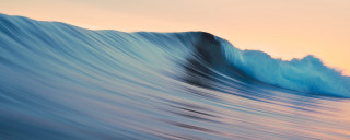 Large wave breaking ocean sunset - soft free wallpaper