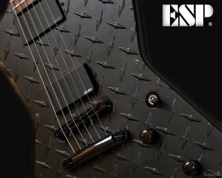 Close up black guitar picker - a close up of a guitar free wallpaper