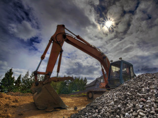 Large machine digging rocks cloudy - a cloudy day free wallpaper