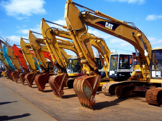 Yellow construction machines cement road - a row free wallpaper