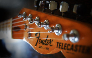 Guitar neck closeup fret logo - a close up of a guitar neck free wallpaper