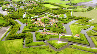 Large green field river town - aerial free wallpaper