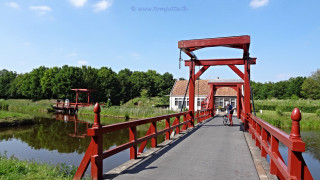 Red bridge river person walking - a house in the background free wallpaper