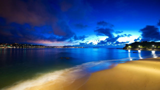 Beach water clouds night lights - a beach free wallpaper for desktop