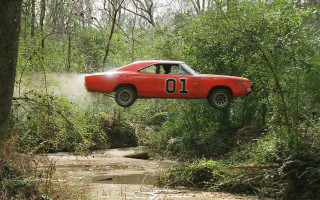 Red car jumping muddy stream - a number free wallpaper