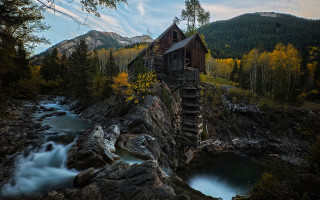 Wooden building rocky hillside river 2 - a wooden building free wallpaper