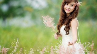 Woman white dress field flowers 2 - a field of flowers and grass free wallpaper