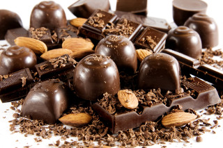 Chocolates nuts pile white surface - decadent free wallpaper