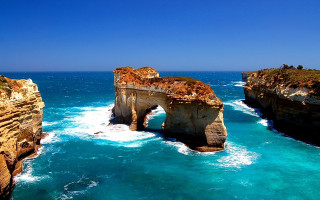 Large body of water rock - a rock formation in the middle of it free wallpaper