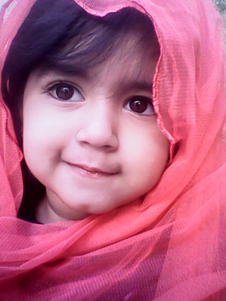 Little girl pink scarf smiling - a little girl free wallpaper